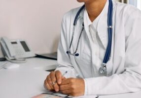 Group of healthcare providers discussing MSSP and ACO REACH strategies.